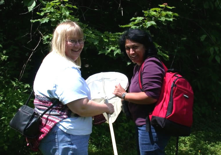 Kathryn Dau-Schmidt (left) and Christine Noronha looking for butterflies in Odell Park.  Photo by Jon Sweeney.