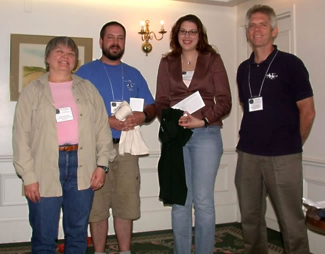Awards presented for best student papers at the 2005 AES Meeting, left to right: Kenna MacKenzie, President of the AES; Andrew Morrison, runner up; Pauwlina Dexter, first prize; Jon Sweeney, Past-President.  Photo by George Fanjoy.